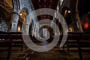 Interior of Ancient Church Cathedral with pillars, arches, and stained glass windows in Scotland, UK