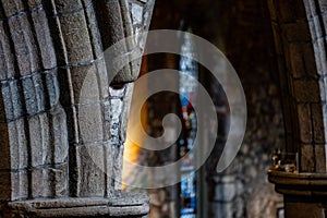 Interior of Ancient Church Cathedral with pillars, arches, and stained glass windows in Scotland, UK