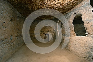 The interior of an ancient underground city on the territory of Cappadocia. Rooms deep underground. The concept of tourism and photo
