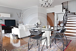 Interior of a apartment, glass table and staircase