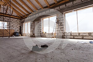 Interior of apartment during under renovation, remodeling and construction a pair of working shoes on the cement floor