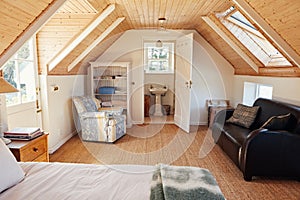 Interior of an attic bedroom with bathroom in a home