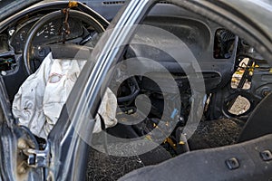 Interior of a automobile or car involved in vehicle crash with a deployed steering column airbag