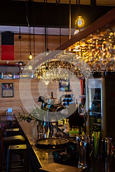 Interior of a bar. Glasses filled with light No people