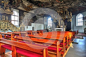 The interior of baroque church in Stegna Poland with ornamental wooden golden altar and pulpit.