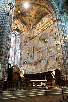 Interior of the basilica of Orvieto with altar and frescoed walls photo