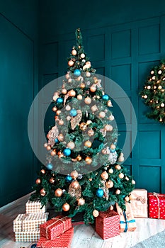 Interior of a beautiful cyan room decorated for Christmas, a lot of gift boxes and presents under a blue fir tree, festive mood