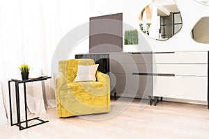 interior of bedroom with yellow armchair