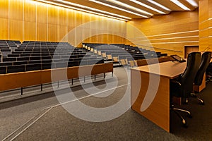 Interior of big conference hall full of gray folding chairs