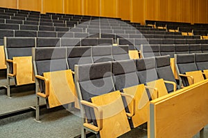 Interior of big conference hall full of gray folding chairs