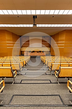 Interior of big conference hall full of gray folding chairs