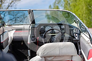 Interior of boat with steering wheel and control panel