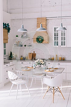 Interior of a bright modern kitchen in vintage style, decorated with Christmas decor