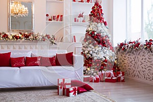 Interior of bright modern living room with fireplace and comfortable sofa decorated with Christmas tree and gifts