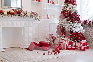 Interior of bright modern living room with fireplace decorated with Christmas tree and gifts