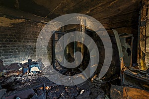 Interior of a burnt by fire apartment in an apartment building, burned furniture