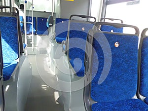 Interior of the bus both on the passenger side with seats and details of the driver`s seat