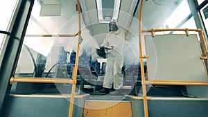 Interior of a bus is getting disinfected with a fumigator