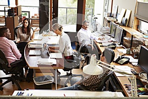 Interior Of Busy Architect's Office With Staff Working