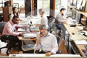 Interior Of Busy Architect's Office With Staff Working