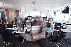 Interior Of Busy Modern Open Plan Office With Staff