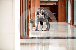 Interior Of Busy Office Foyer Area With Businesspeople.