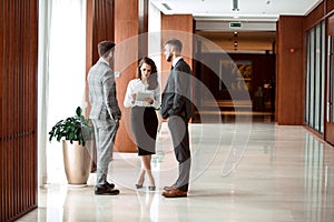 Interior Of Busy Office Foyer Area With Businesspeople.