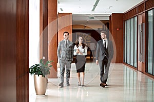 Interior Of Busy Office Foyer Area With Businesspeople.