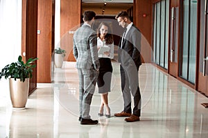 Interior Of Busy Office Foyer Area With Businesspeople.