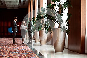 Interior Of Busy Office Foyer Area With Businesspeople.