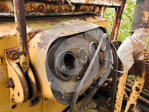 Interior of cabin with levers and instruments panel of abandoned deserted old rusty bulldozer, vintage industrial heavy machine,