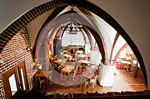 Interior of cafe in the old catholic church with brick walls