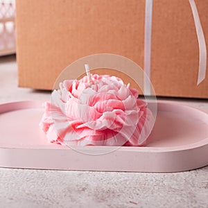 Interior candle in the form of a peony on a tray photo