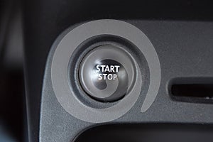 Car interior with closeup of engine start stop system button