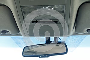 Interior car rearview mirror. Modern car illuminated dashboard. Luxurious car instrument cluster. Close up shot of automobile inst