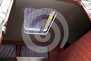 The interior of the car van with closed aluminium sunroof and led lighting. Auto service industry