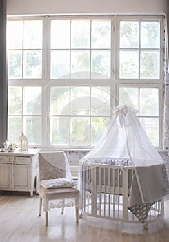 Interior of the children`s room, Provence style, oval baby cot, with canopy, light interior, large beautiful window
