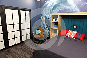 The interior of the children`s room, the room of the teenager in red blue tones