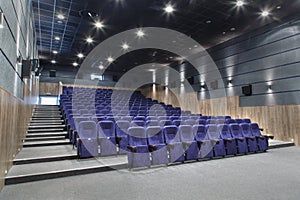 Interior cinema hall with plenty of seating and a projector