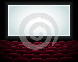 Interior of a cinema movie theatre, lecture hall with copyspace on the screen and rows of blue cinema or theater seats