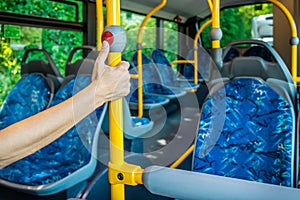 Interior of a city bus. Empty bus interior. Bus with blue seats and yellow handrails