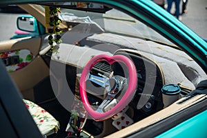 Interior of a classic car with a vintage heart-shaped steering wheel
