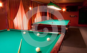 Interior of a club having billiard tables