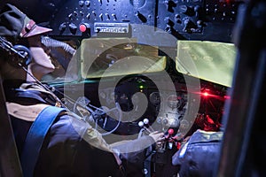 cockpit of an old American bomber plane from World War II during a night storm