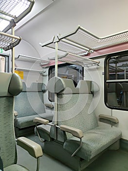 interior of a commuter train car with soft seats