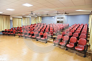 Interior of conference hall with red chairs