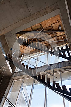 Interior of a construction site of a multi-storey building. Installation of steel stairs using steel i-beams.