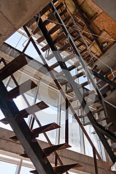 Interior of a construction site of a multi-storey building. Installation of steel stairs using steel i-beams.