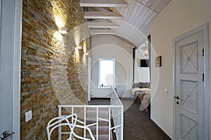 Interior of a contemporary home with spacious hallway, room doors and staircase railing in modern style