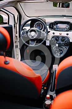 The interior of the convertible car. Inside a small convertible car with red interior